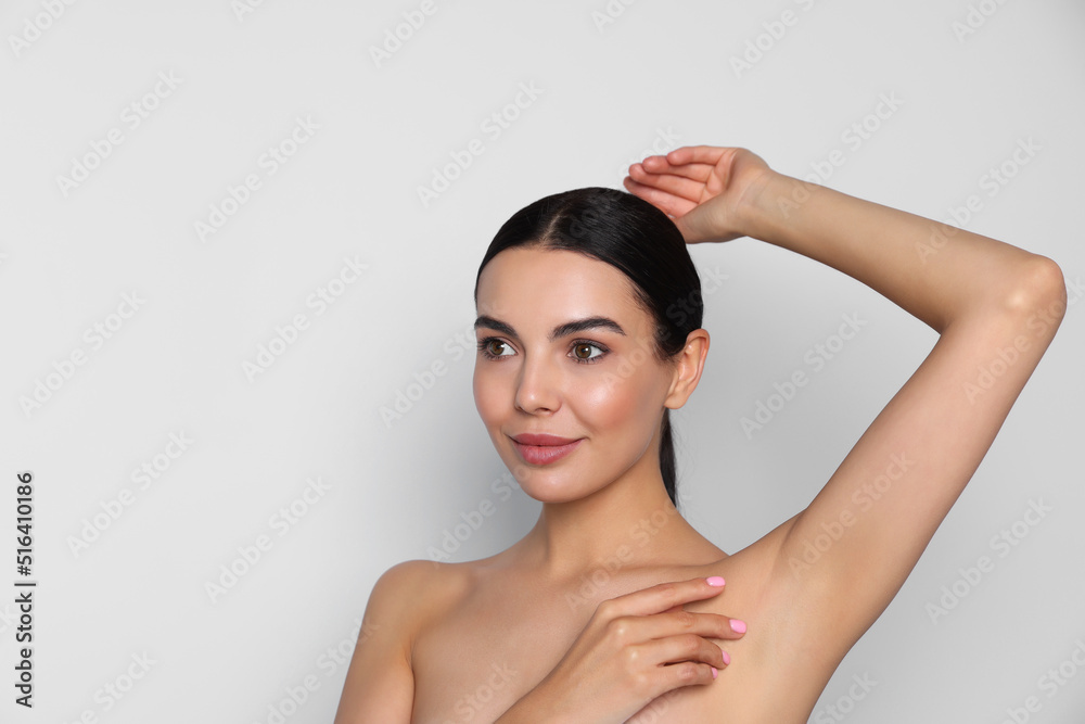 Young woman showing smooth skin after epilation on white background, space for text Young woman showing smooth skin after epilation on white background, space for text