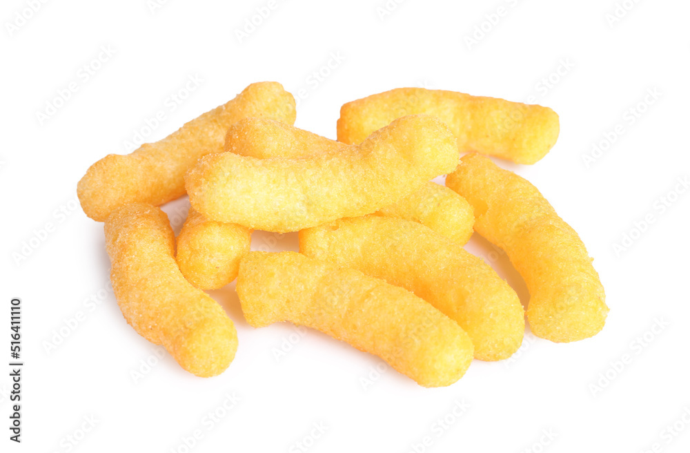 Many tasty cheesy corn puffs isolated on white