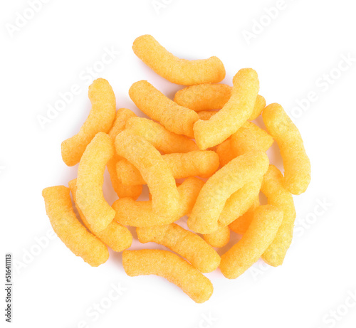 Many tasty cheesy corn puffs isolated on white, top view