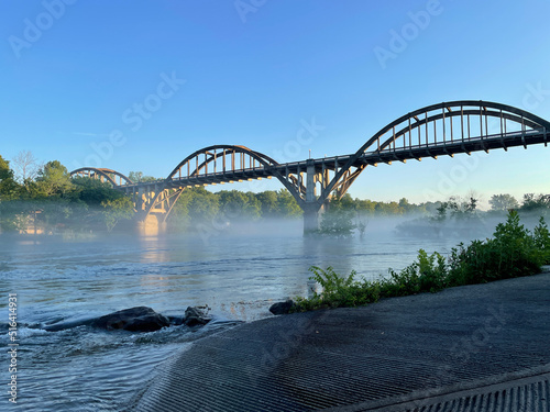 Rainbow Arch Bridge over the White River at the public access in Big Spring Park in Cotter Arkansas photo