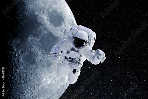 Fototapeta Naklejka Na Ścianę i Meble -  Astronaut in outer space on a background of moon. National Moon Day. Conceptual image. Elements of this image furnished by NASA.