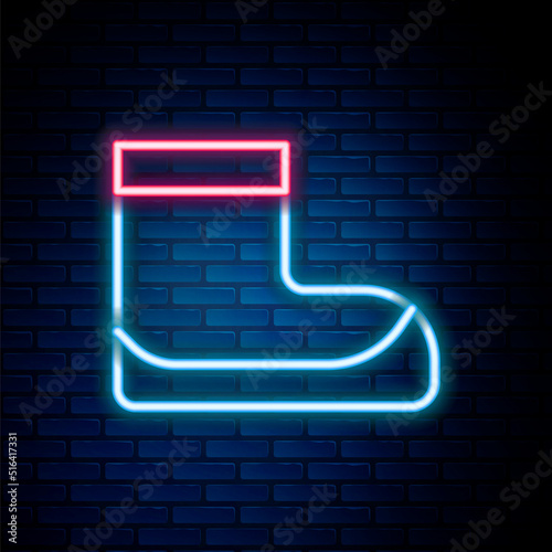Glowing neon line Boots icon isolated on brick wall background. Diving underwater equipment. Colorful outline concept. Vector