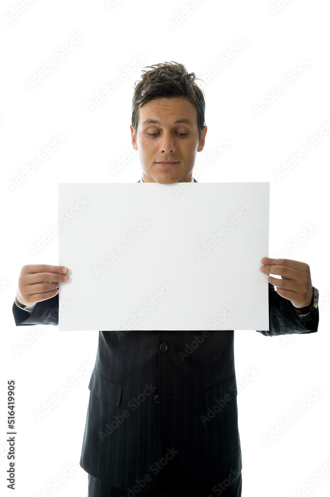 Businessman is Holding an Blank Paper Against White Background Businessman is Holding an Blank Paper Against White Background