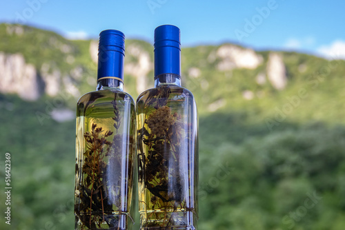 Aromatic home made and very healthy brandy (Serbian Rakija) with different herbs inside the bottle, perfect decorative gift photo