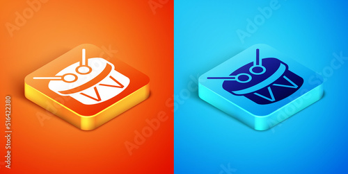 Isometric Musical instrument drum and drum sticks icon isolated on orange and blue background. Vector