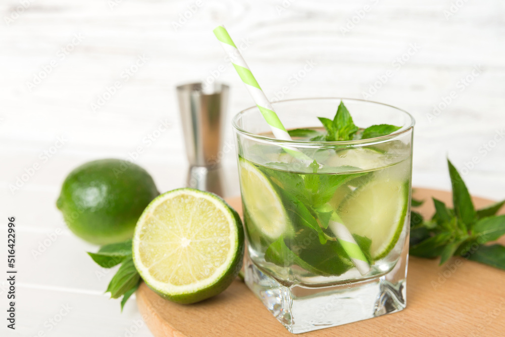 Mojito cocktail. Refreshing mojito cocktail with lime, lemon and mint in a tall glass with a stick Mojito cocktail. Refreshing mojito cocktail with lime, lemon and mint in a tall glass with a stick