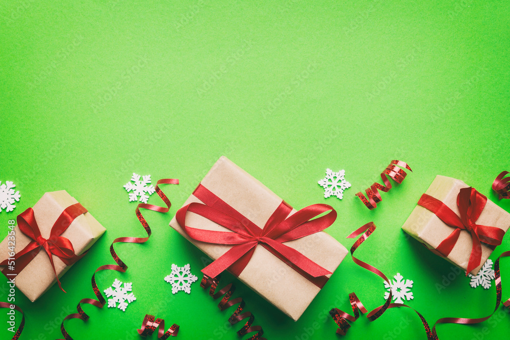 Holiday flat lay with gift boxes wrapped in colorful paper and tied decorated with confetti on colored background. Christmas, Birthday, Valentine and sale concept, top view Holiday flat lay with gift boxes wrapped in colorful paper and tied decorated with confetti on colored background. Christmas, Birthday, Valentine and sale concept, top view