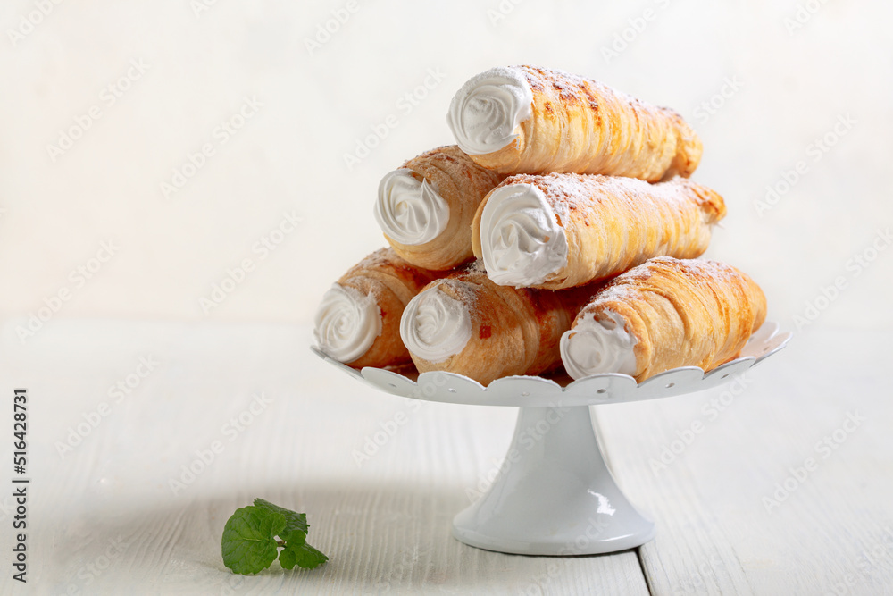 Homemade cakes - puff cones with cream.