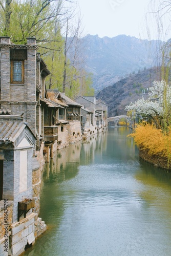 Vertical of old building reflecting in a canal in Gubei water town, China in autumn photo