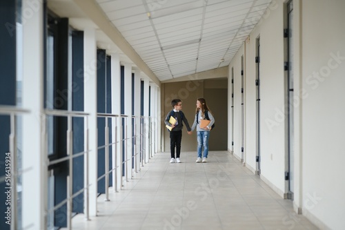 Happy school kids in corridor at school © Serhii