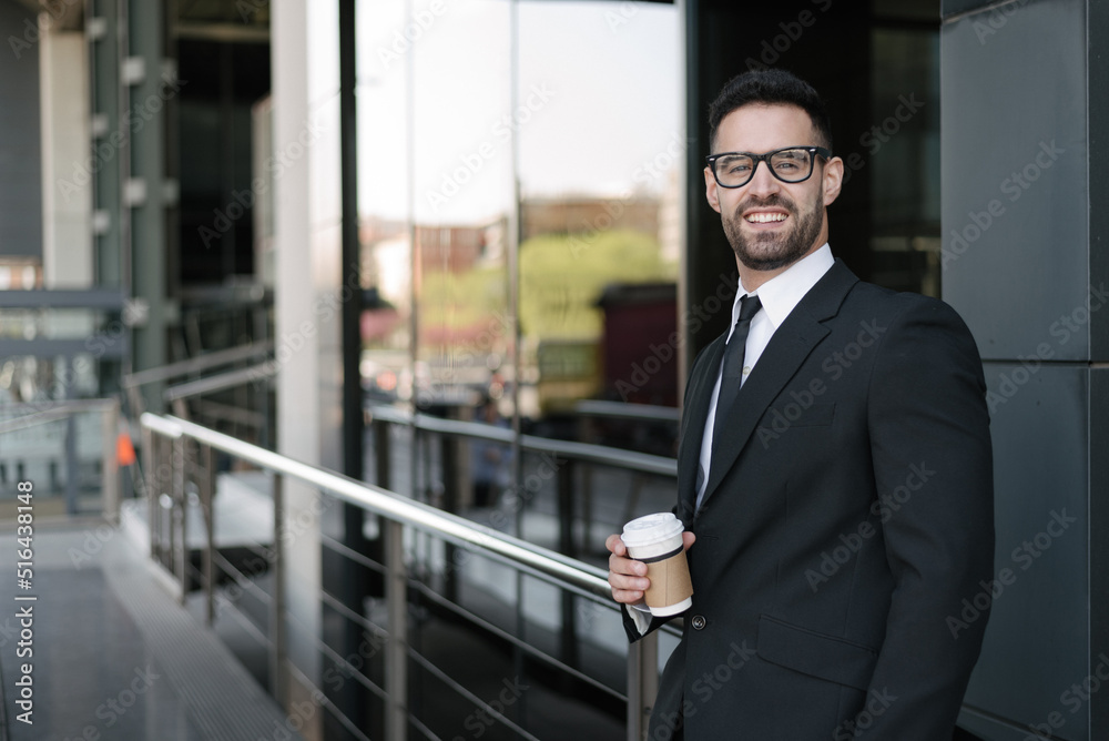 man in suit drinking coffee at business street man in suit drinking coffee at business street
