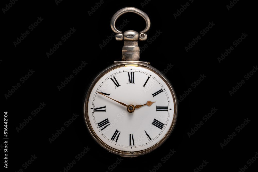 Dial of silver antique pocket watch on isolated black background. Old mechanical clock. Round retro pocketwatch with minute and hour hands. Vintage expensive watch. Symbol of time, luxurious life. Dial of silver antique pocket watch on isolated black background. Old mechanical clock. Round retro pocketwatch with minute and hour hands. Vintage expensive watch. Symbol of time, luxurious life.
