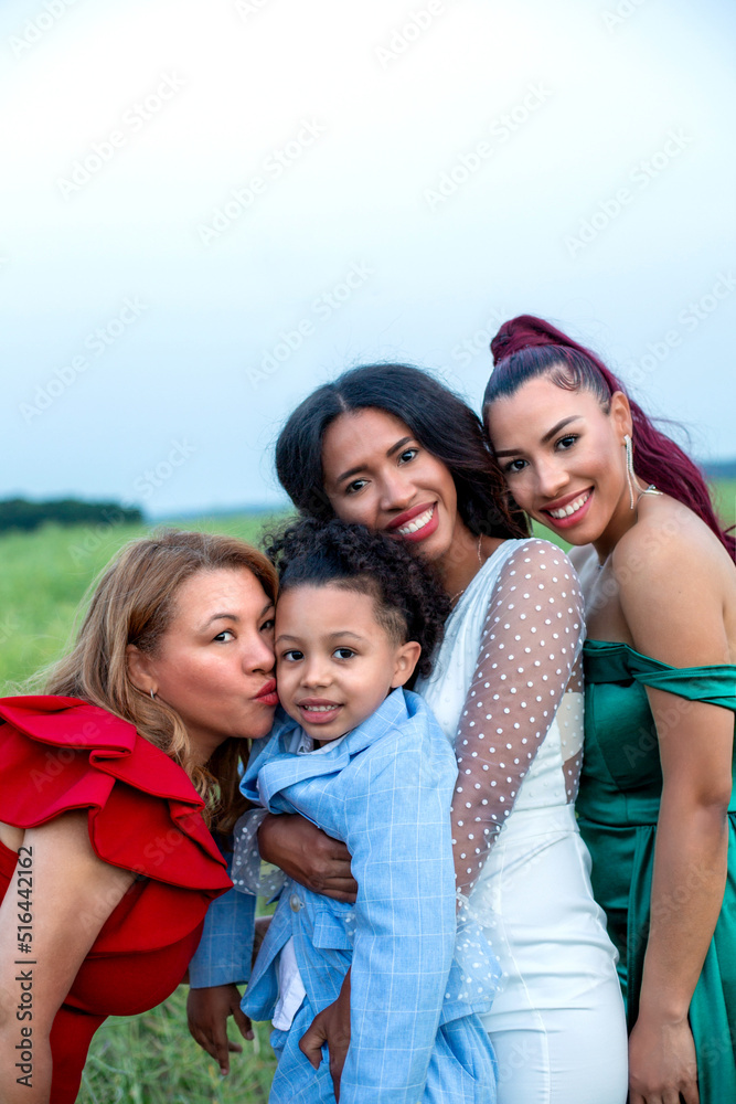 group of hispanic women with a boy outdoors group of hispanic women with a boy outdoors