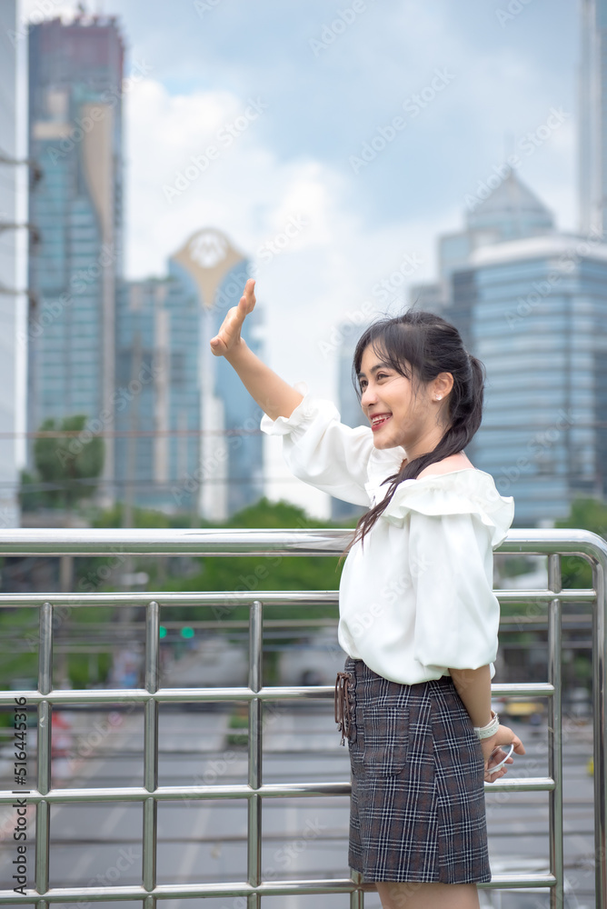 Fototapeta premium smiling woman standing happily in the park