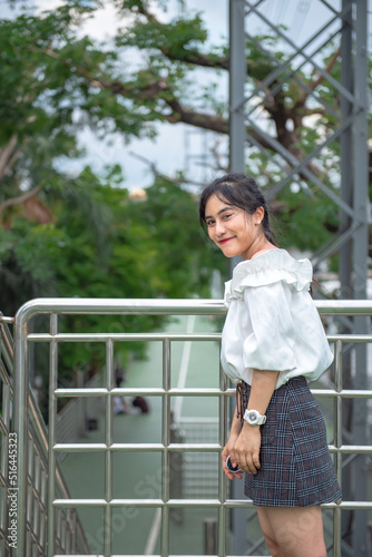 smiling woman standing happily in the park Free Download smiling woman standing happily in the park - GFXLoad