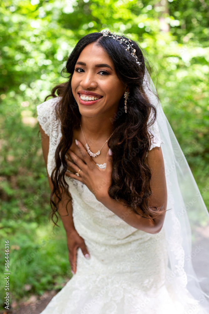 beautiful african-american bride standing in a white gown outdoors in nature beautiful african-american bride standing in a white gown outdoors in nature