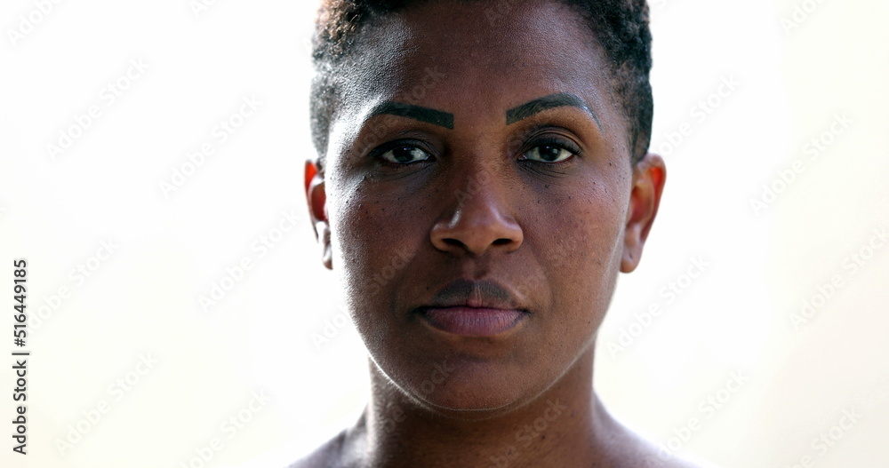 African woman putting covid face mask, black ethnicity female looking at camera African woman putting covid face mask, black ethnicity female looking at camera