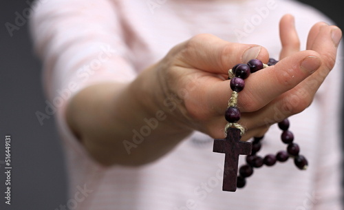 hand holding cross praying to god stock photo