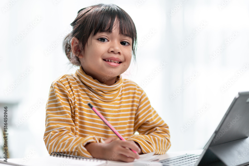 Asian girl students in online learning classes study online with Tablet at home. Asian girl students in online learning classes study online with Tablet at home.
