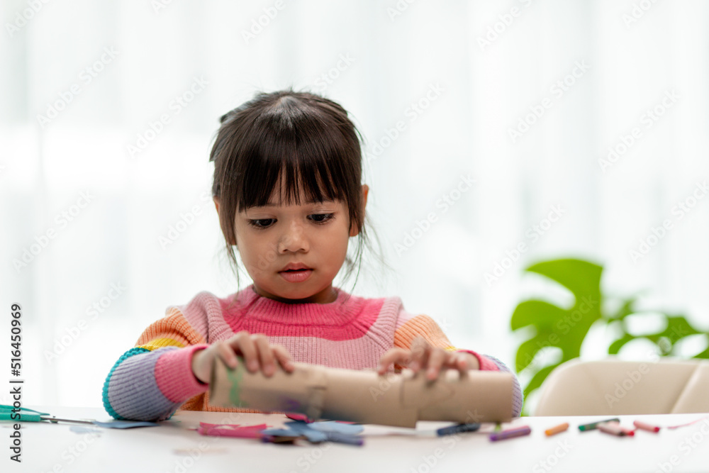 Little Asian girls are making tissue paper core binoculars. Reuse waste products. Idea custom made toy. Soft focus. Little Asian girls are making tissue paper core binoculars. Reuse waste products. Idea custom made toy. Soft focus.