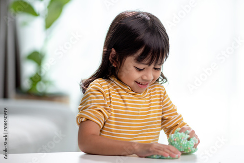 Kid play with handgum. Slime in children hands.