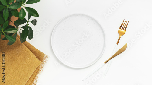 Empty plate with fork and knife on white background. Top view.