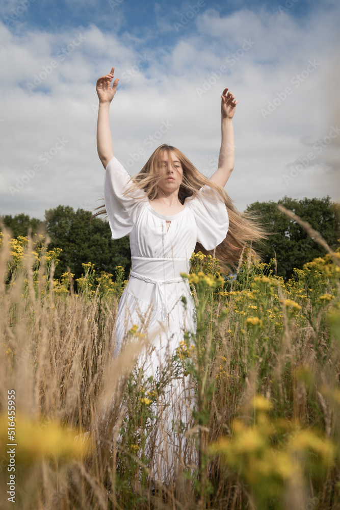 Summer portrait of woman in white dress dancing in the field Summer portrait of woman in white dress dancing in the field