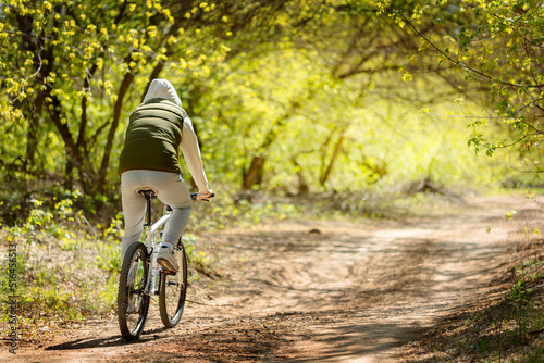 Man on bicycle rides through spring blooming park on sunny day. High quality photoMan on bicycle rides through spring blooming park on sunny day 