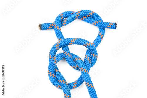 durable colored rope for climbing equipment on a white background. knot of braided cable. item for tourism and travel