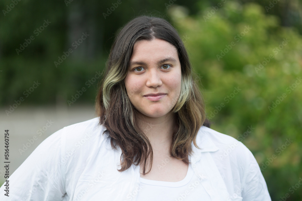 Portrait of a fat woman in a white blouse in the park.A walk in the park.