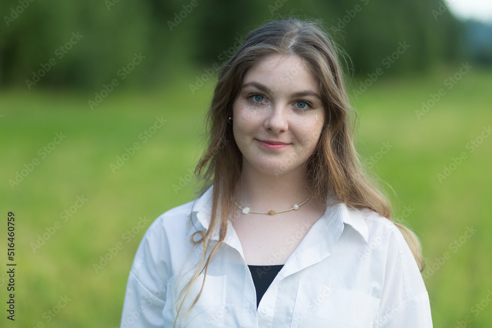 Portrait of a beautiful girl with red hair and freckles on her face. Portrait of a beautiful girl with red hair and freckles on her face.