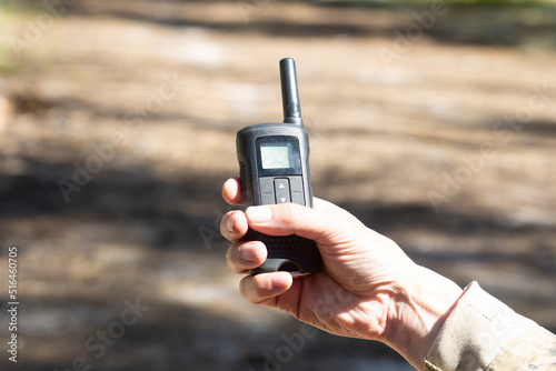 Walkie-talkies.Using walkie-talkies in the forest to transmit messages.