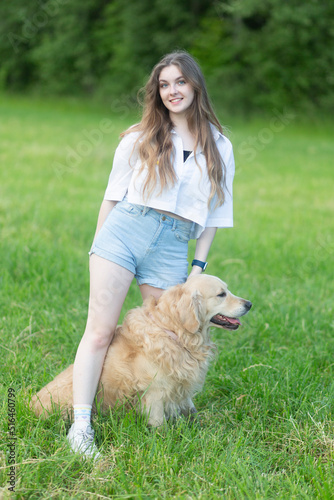 Girl with a dog, Golden Retriever. A girl with a dog in the park.