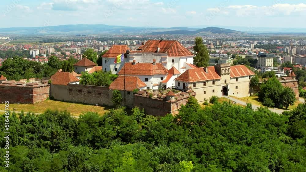 Aerial drone view of The Citadel in Brasov, Romania. Medieval fortress on the top of a hill. Buildings, green trees Aerial drone view of The Citadel in Brasov, Romania. Medieval fortress on the top of a hill. Buildings, green trees