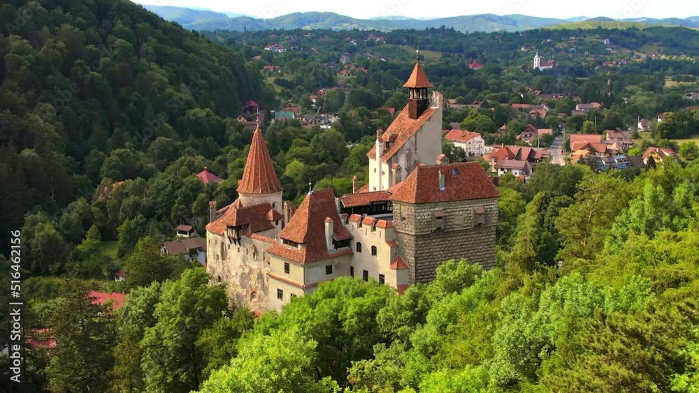 Aerial drone view of The Bran Castle in Romania. Medieval castle in Carpathians, green trees around Aerial drone view of The Bran Castle in Romania. Medieval castle in Carpathians, green trees around