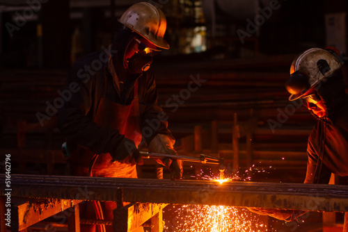 Two workers cutting steel with an industrial oxy acetylene torch