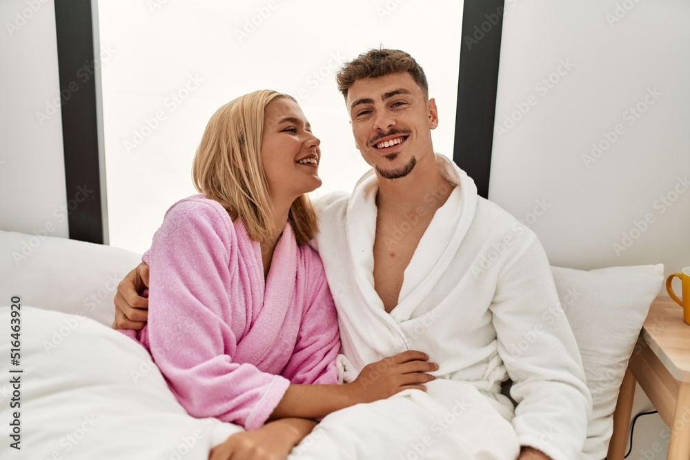Young caucasian couple smiling happy and hugging on the bed at home. Young caucasian couple smiling happy and hugging on the bed at home.