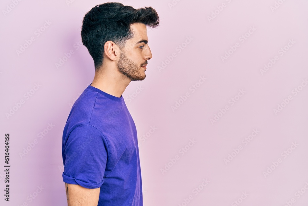 Young hispanic man wearing casual t shirt looking to side, relax profile pose with natural face and confident smile. Young hispanic man wearing casual t shirt looking to side, relax profile pose with natural face and confident smile.