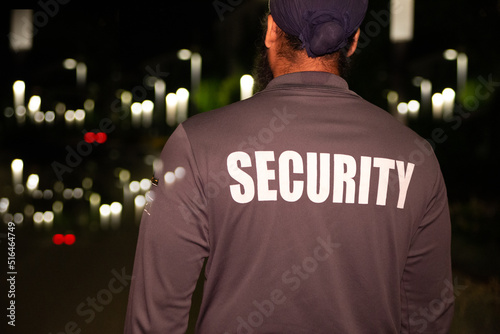 Security guard patrolling city streets at night