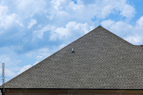 Construction work  shingles covered in asphalt are being used for the roof of a house
