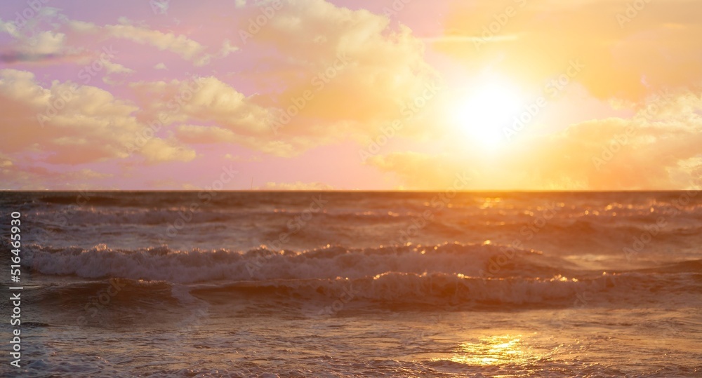 Obraz premium Beautiful sea at sunset. Dramatic sky with glowing clouds. Setting sun. Abstract natural