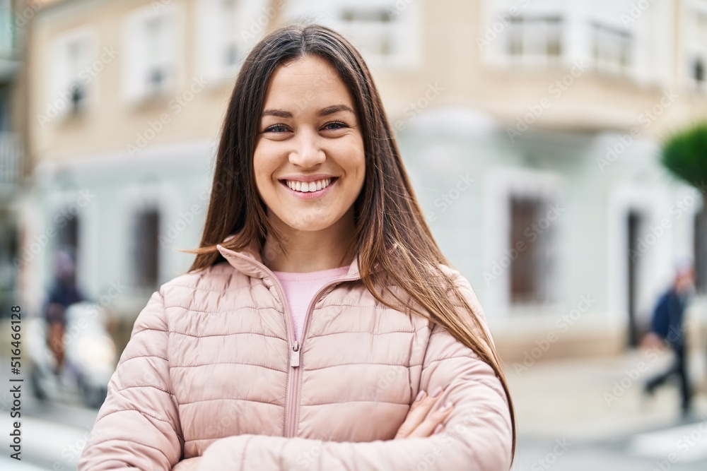 Young woman smiling confident standing with arms crossed gesture at street Young woman smiling confident standing with arms crossed gesture at street