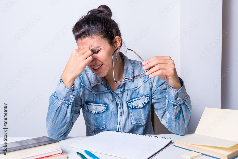 young latina woman, taking off her glasses because her eyes hurt, presbyopia, eyesight, eye doctor young latina woman, taking off her glasses because her eyes hurt, presbyopia, eyesight, eye doctor