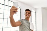 Young hispanic man smiling confident make selfie by the smartphone at sport center