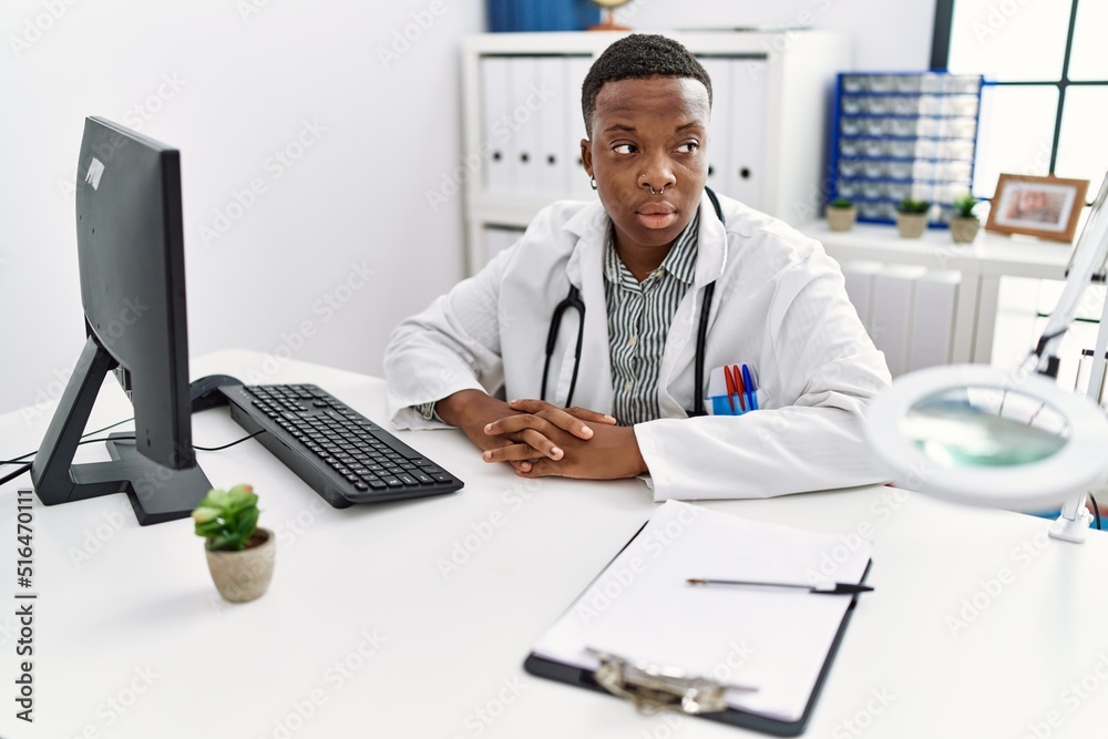 Young african man working as doctor at medical clinic