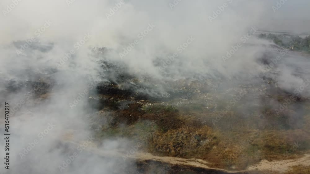 Aerial ascending look fire burning at landfill site cause air pollution Aerial ascending look fire burning at landfill site cause air pollution
