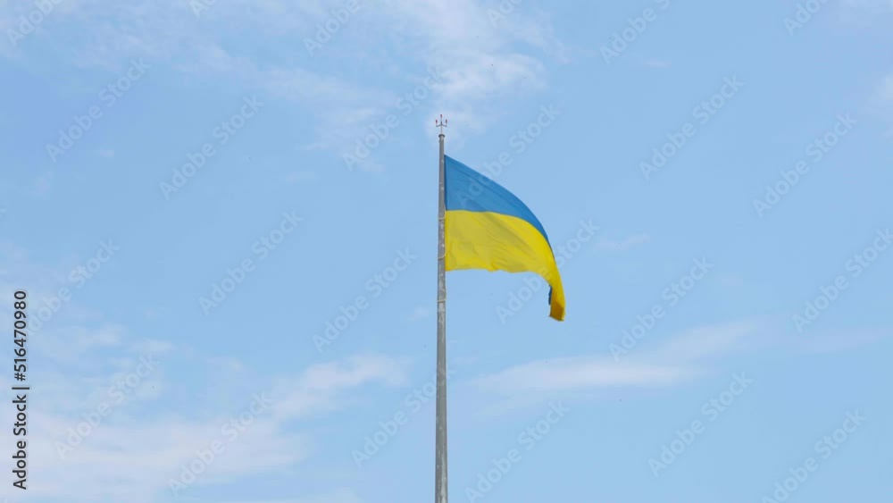 Flag of Ukraine waving in the wind, blue sky, highly detailed fabric texture yellow blue flag of Ukraine. Flag of Ukraine waving in the wind, blue sky, highly detailed fabric texture yellow blue flag of Ukraine.