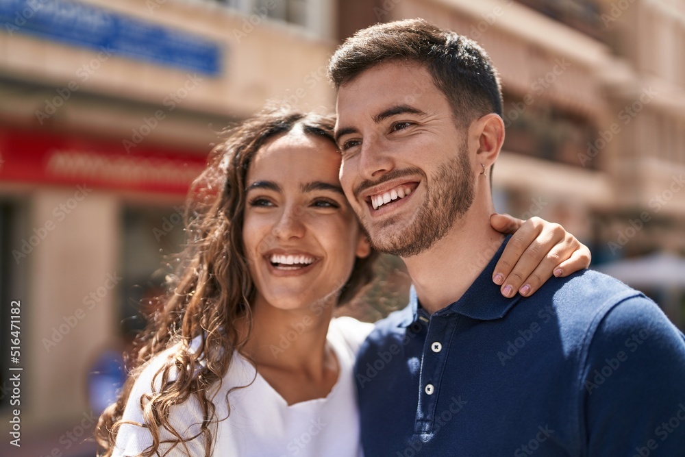 Young hispanic couple smiling confident hugging each other at street Young hispanic couple smiling confident hugging each other at street