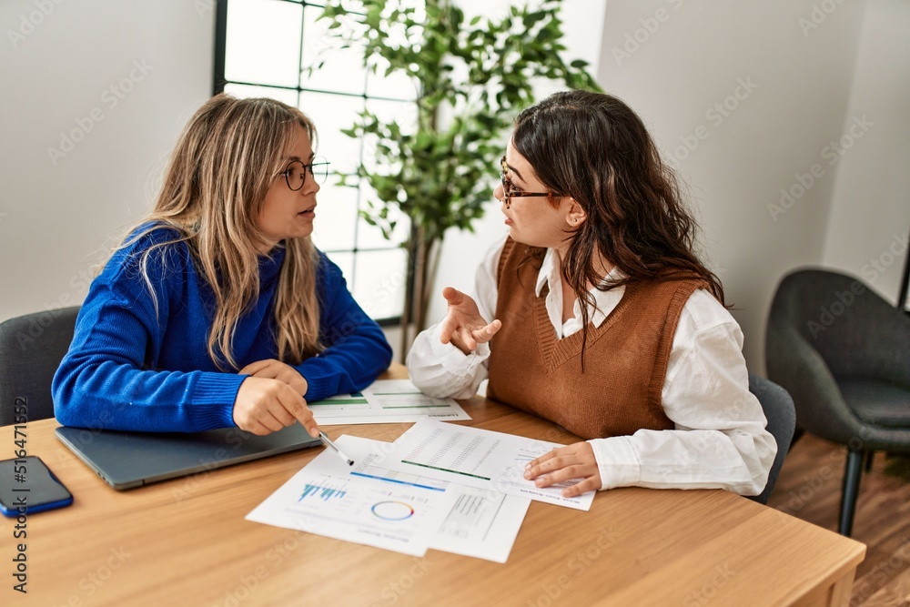 Two business workers woman smiling happy working at the office. Two business workers woman smiling happy working at the office.