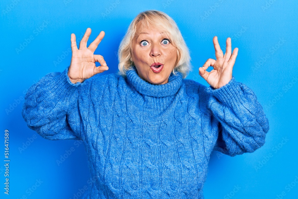 Middle age blonde woman wearing casual clothes looking surprised and shocked doing ok approval symbol with fingers. crazy expression Middle age blonde woman wearing casual clothes looking surprised and shocked doing ok approval symbol with fingers. crazy expression
